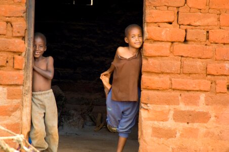 masai children resting beside their home photo