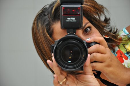 Woman shooting gray camera