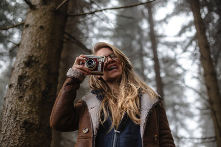 Woman in the Forest Hand Holding Retro Camera photo