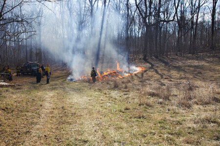 Firefighters gather around small burn area photo