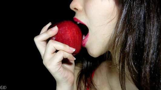 Beautiful Woman Eating An Apple photo