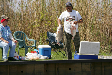 Man showing his catch at Lacassine National Wildlife Refuge photo