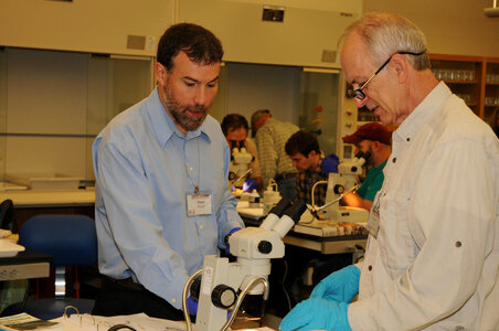 Instructor and student identify fish in the lab classroom