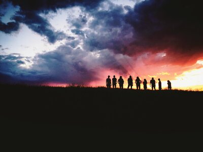 Silhouette Group of People Looking at Beautiful Sunset Sky photo