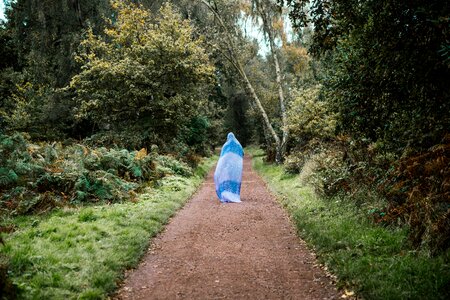 Woman Walking Path With Head Covered photo