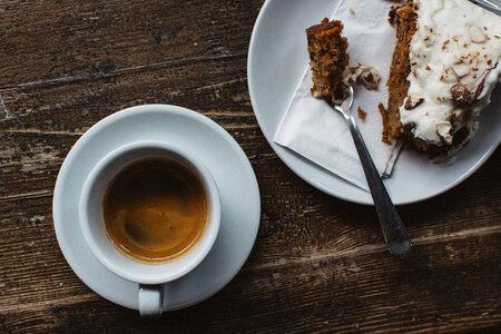 Espresso with carrot cake at a wooden table photo