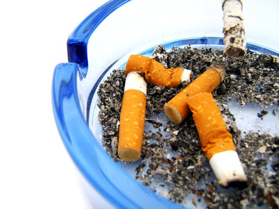 cigarettes in blue ashtray