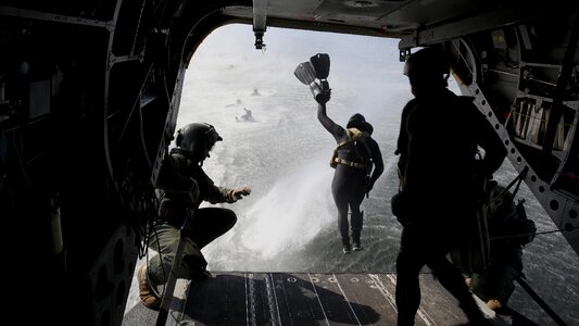 Marine jumps from the ramp of a CH-47 photo