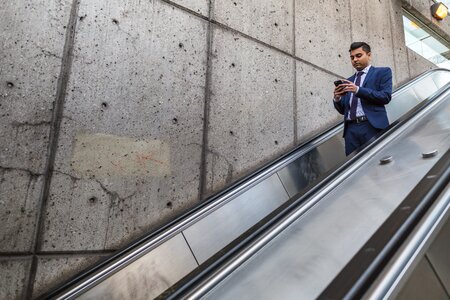 Businessman On Escalator