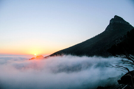 Sunrise above the clouds on the Mountain in Cape Town, South Africa photo