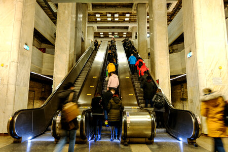People Standing on Automatic Stairs