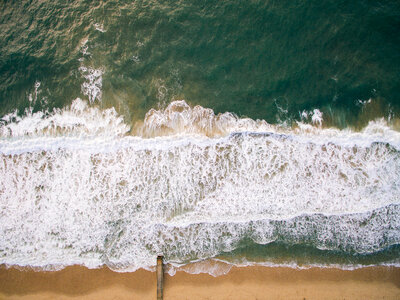 Aerial View of Ocean with Waves and Sand photo