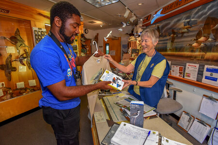 FWS volunteer with visitor in gift shop-1