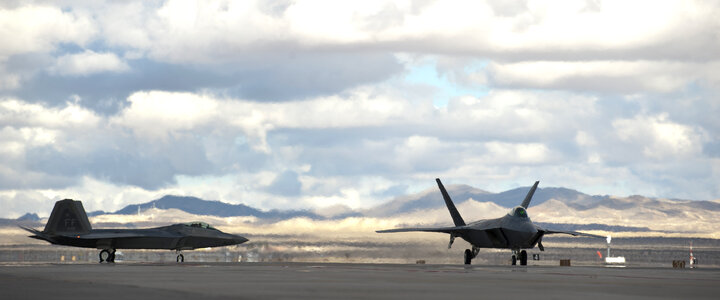 Two F-22 Raptors taxi to the runway photo