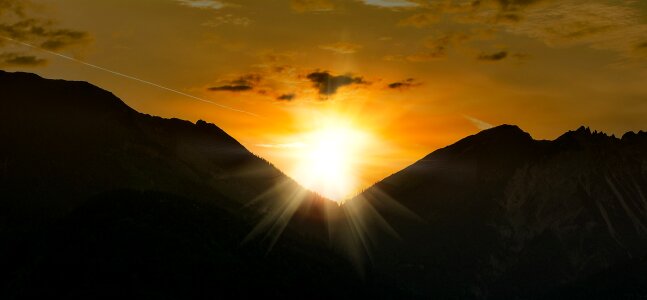 Mountain peaks sun lighting photo