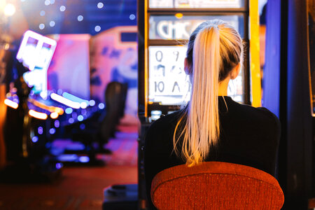 2 Young woman playing at slot machine in casino photo