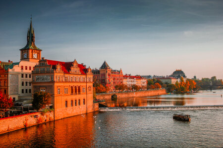 Sunset view of the river and shoreline buildings in Prague, Czech Republic