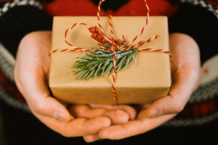 1 Man’s hands hold christmas gift box. Merry Christmas photo