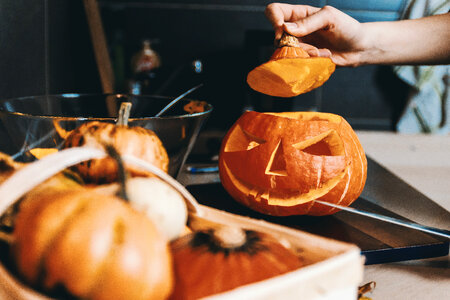 2 Girls hands carve the pumpkin. Halloween. photo