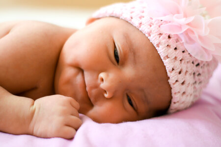 Little Baby Girl Lying on Pink Blanket photo