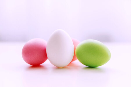 Happy Easter! Colorful Easter eggs on white table. photo
