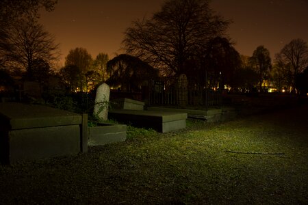 Spooky night tombstones photo