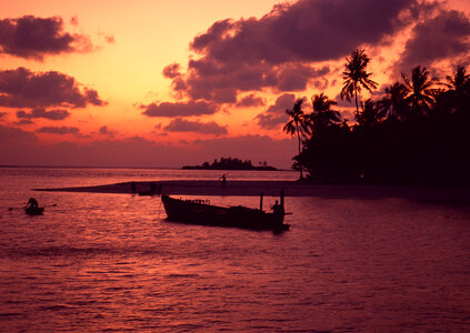 Sunset with an fishing boat photo