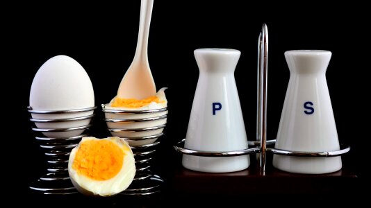 Open soft boiled egg in egg cup photo