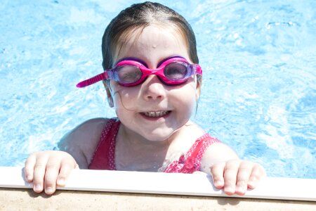Cute little girl in swimming pool photo