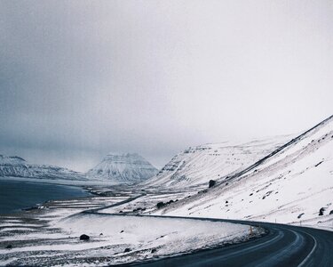 Winter Winding Road Through the Mountainous Wilderness photo