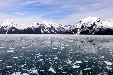Landscape with snow-capped mountains with ice and water in Alaska photo