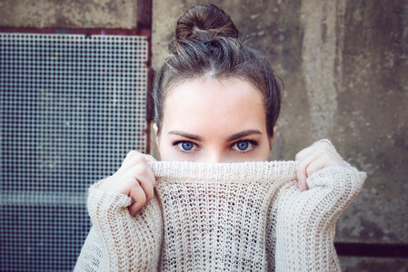 Young Woman Face Hidden behind Sweater photo