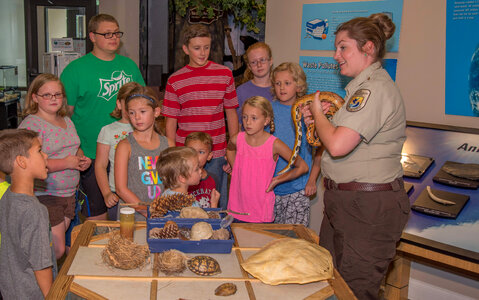 Visitor center program with FWS employee holding snake