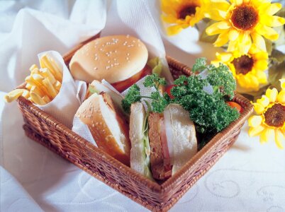 a cheeseburger with deep fried potatoes, closeup photo