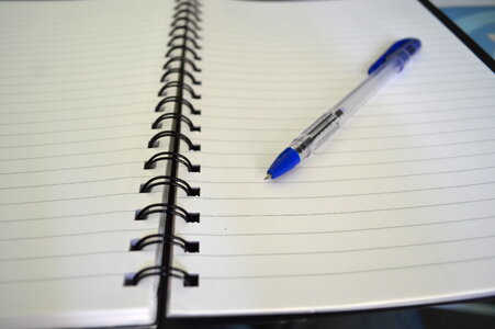 Pen On Spiral Ruled Paper Notebook