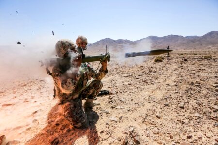 Soldiers fire a rocket-propelled grenade