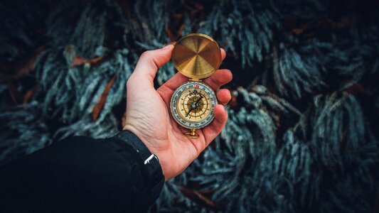 Man Holding Vintage Compass photo