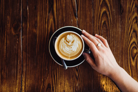 Feale Hand Holding Cup of Coffee photo