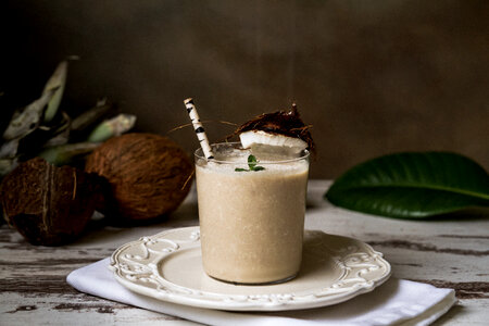 Stylish Coconut Milk Beverage with a Straw photo