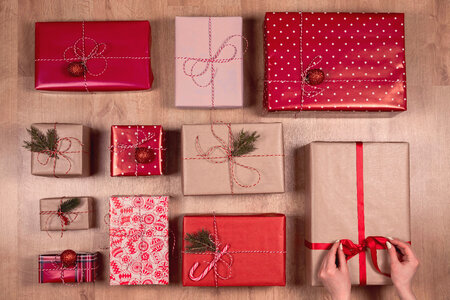 Collection of Christmas presents arranged on a wooden background photo