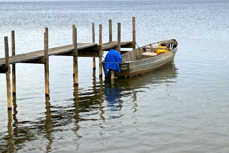 Fisherman fishing boat alone photo