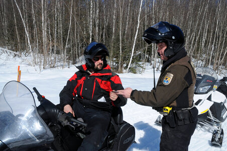 Service Law Enforcement Officer checks a sled driver-3