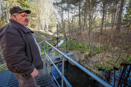 FWS employee at Pendills Creek National Fish Hatchery looking at water source