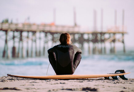 Surfer on the Beach with His Board photo