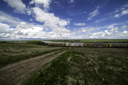 Train under the clouds and sky in Saskatchewan photo