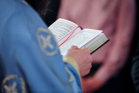 Reading priest bible
