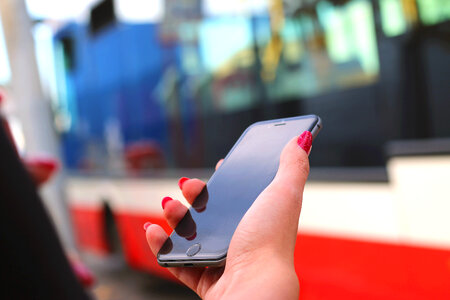 Black modern smartphone in hand woman on the street photo