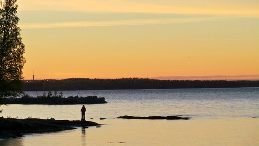 Fishing spinning at sunset. Silhouette of a fisherman photo