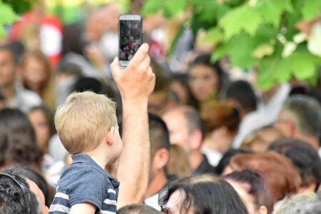 Cellphone child crowd photo