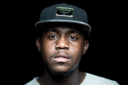 Portrait of Young Man with Cap On Black Background photo